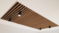 the ceiling is covered with wooden slats