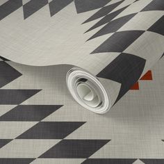 a black and white wallpaper with an orange triangle design on it's side