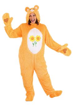 a woman in a yellow bear costume standing up with her arms out and smiling at the camera