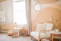 a child's room decorated in peach and white