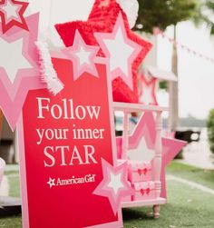 pink and white stars are on display at an american girl party