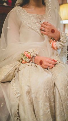 a woman in a white wedding dress sitting down