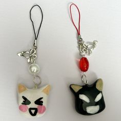 two key chains with cats on them