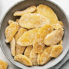 a bowl filled with sugared bananas on top of a table