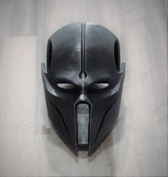 a black mask with two holes in the middle