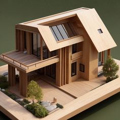 a wooden model of a house with trees and rocks