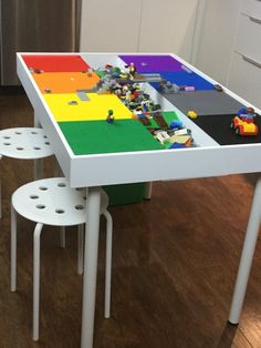 a table with legos on it in the middle of a kitchen