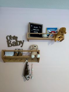 two wooden shelves with books and stuffed animals on them, hanging from the wall in a child's room