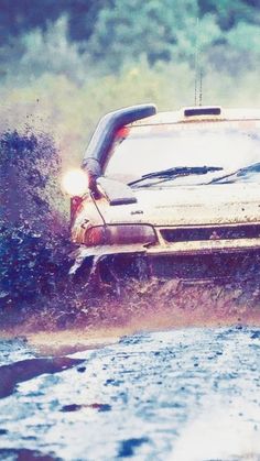 a car is driving through some water in the rain