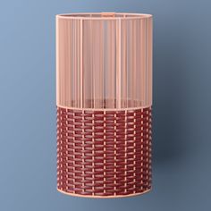 a red and pink vase sitting on top of a blue wall