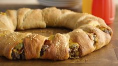 a sausage and cheese crescent pastry on a cutting board