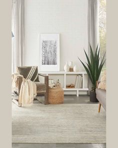 a living room filled with furniture and a white brick wall in the backround