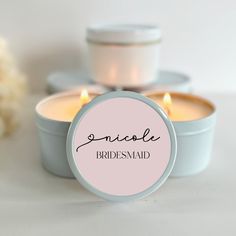 two small candles sitting next to each other on top of a white table with the words smile bridesmaid