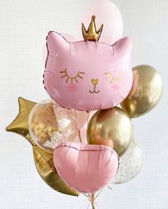 a bunch of balloons that are shaped like cats and kittens with crowns on them