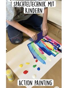 a young child is painting on a piece of paper with words above it that read, spacellechnik mit kindern action painting