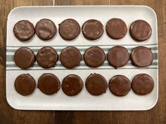 chocolate covered cookies sitting on top of a white plate