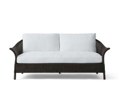 an outdoor sofa with white cushions