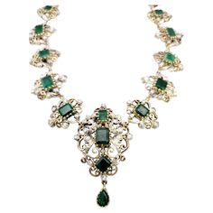 Transport yourself to a world of timeless beauty and sophistication with this extraordinary antique Victorian era graduated necklace. Adorned with mesmerizing emeralds and dazzling diamonds, this exquisite piece captures the essence of a bygone era. The necklace showcases a captivating arrangement of graduated emerald gemstones, carefully selected for their rich green color and exquisite clarity. Each emerald is meticulously set in an intricate scroll motif link crafted from lustrous 14K yellow Luxury Victorian Flower Pendant Jewelry, Luxury Vintage Rose Cut Diamond Necklace, Luxury Antique Jewelry With Rectangular Stone, Elegant Emerald Necklaces With Intricate Design, Elegant Ceremonial Emerald Necklace With 17 Jewels, Vintage Diamond Gemstone Necklace, Vintage Diamond Necklace With Gemstones, Elegant Emerald Bridal Necklace With Intricate Design, Vintage Green Jewelry With Single Cut Diamonds