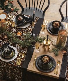 the table is set with black and gold plates