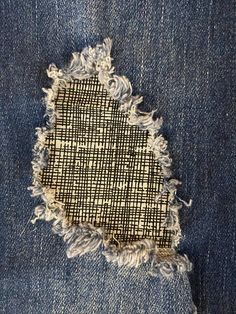 an old pair of jeans with holes in it