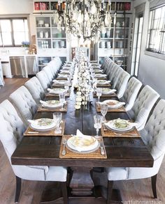 a dining room table is set with plates and place settings for six to eight people