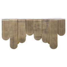 a gold console table with five curved legs