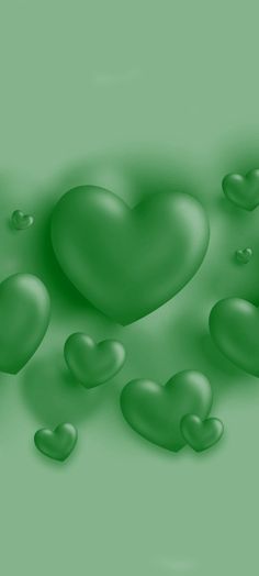 green hearts floating in the air on a green background