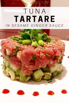 tuna tartare in sesame ginger sauce on a white plate with garnishes