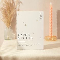 a table is set with two candles and a card that says table eight on it