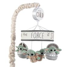 a star wars mobile with two baby yoda toys hanging from it