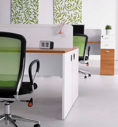 an office with green chairs and white desks