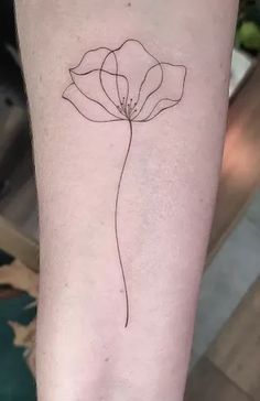 a single line flower on the arm