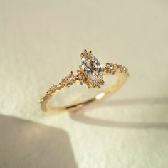 a yellow gold engagement ring with two pear shaped diamonds