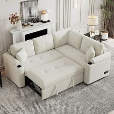 a living room with white furniture and a fireplace in the corner, including a sectional sofa