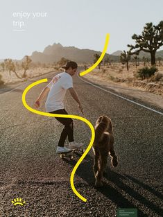 a man riding a skateboard down the middle of a road with a dog walking behind him