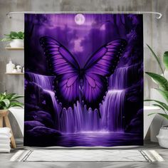 a purple shower curtain with a waterfall and a butterfly in the sky on it's side