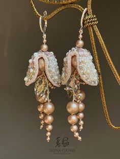 the earrings are adorned with pearls and beadwork, along with other jewelry pieces