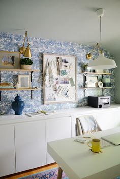 a dining room with blue and white wallpaper