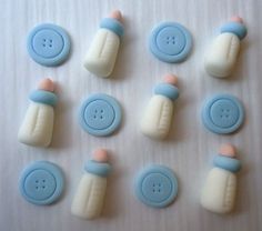 several blue and white buttons are arranged on a table