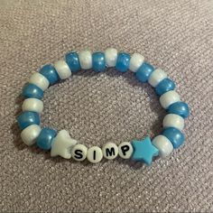 a blue and white beaded bracelet with the word smp spelled out on it