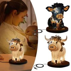 a woman is working on a cow lamp with the light turned to look like it has horns