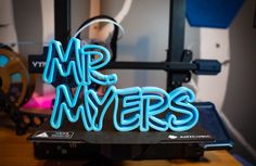 a neon sign that says mr and mrs on top of a table in front of a camera