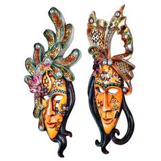 two masks with different designs on them are hanging from the side of each other's heads