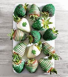 chocolate covered strawberries are arranged in the shape of shamrocks and strawberrys with green leaves on them