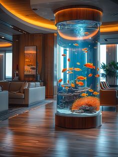 a fish tank in the middle of a living room with wood flooring and large windows