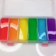 six different colors of paint in a plastic container