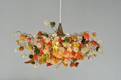 a chandelier with many different colored glass pieces hanging from it's ceiling