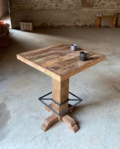 a wooden table sitting on top of a cement floor