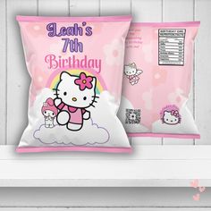 two hello kitty pillows sitting on top of a shelf