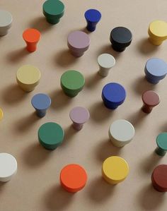 many different colored wooden knobs on a table